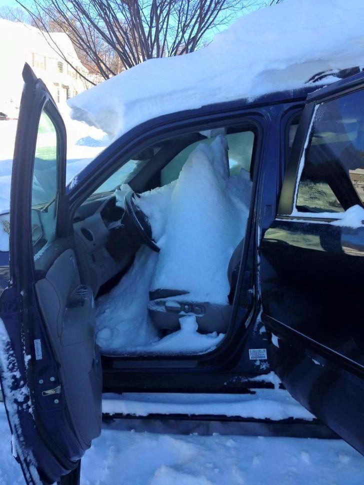 mildly infuriating pic of snow piled up inside a car