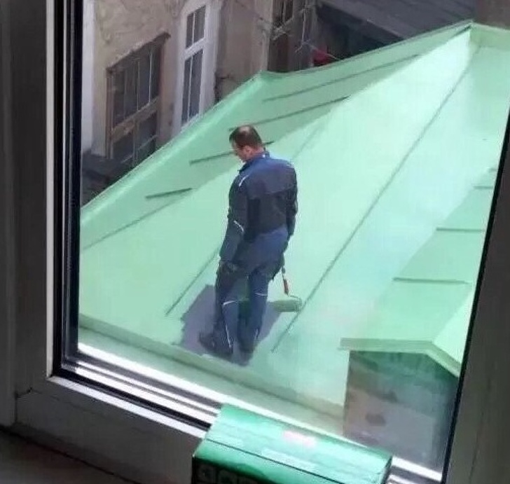 mildly infuriating pic of man trapped on newly painted roof
