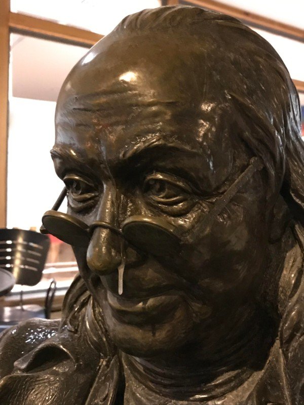 The ice forming on this stature of Ben Franklin makes it look like he has a runny nose.