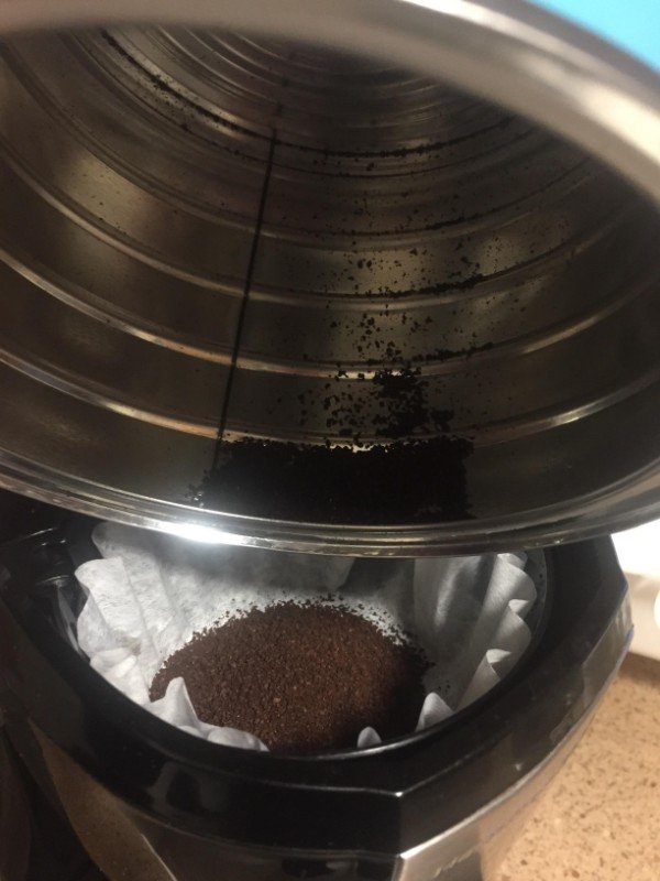 The lip in the coffee tin stopping you from properly emptying it out with ease.