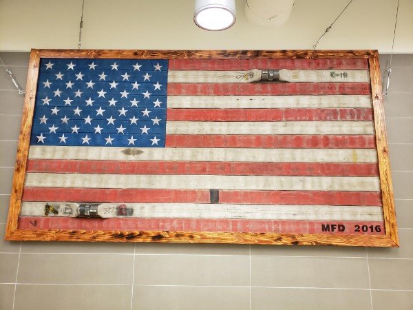 Flag made from old fire hoses.
