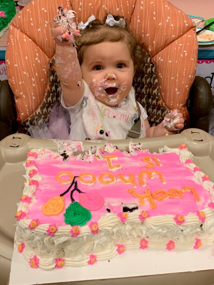 baby eating birthday cake