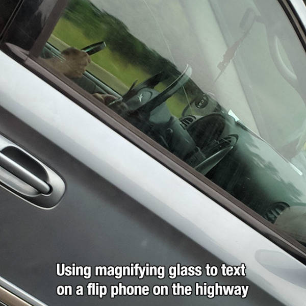 vehicle door - ca Using magnifying glass to text on a flip phone on the highway