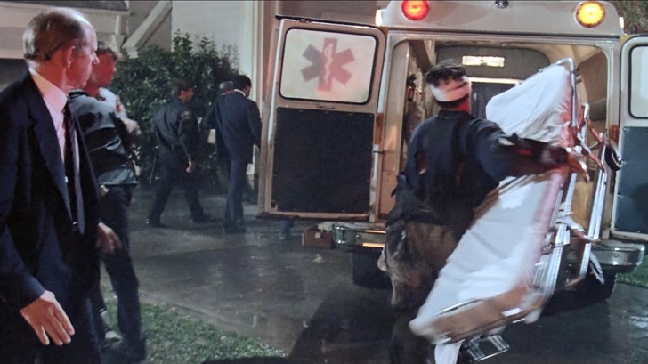 Tom Hanks in the 80s comedy The Burbs carrying a stretcher into the back of an ambulance