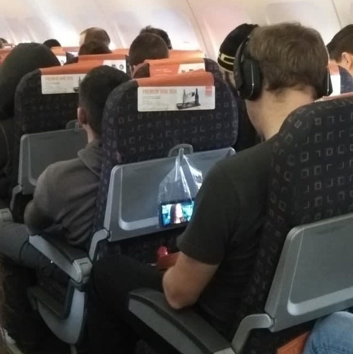 A bag can be a phone holder on a plane.