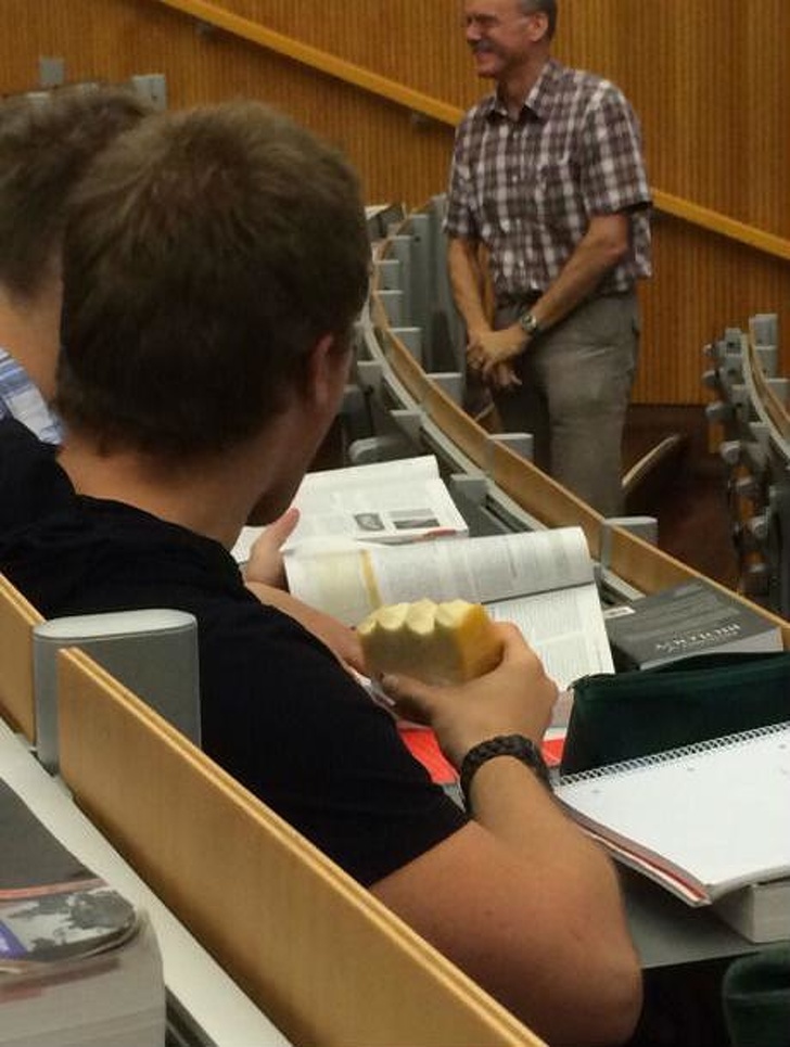 guy eating cheese in class