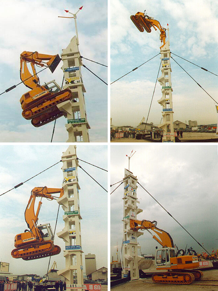 A track excavator climbing a purpose-built tower to show its might.