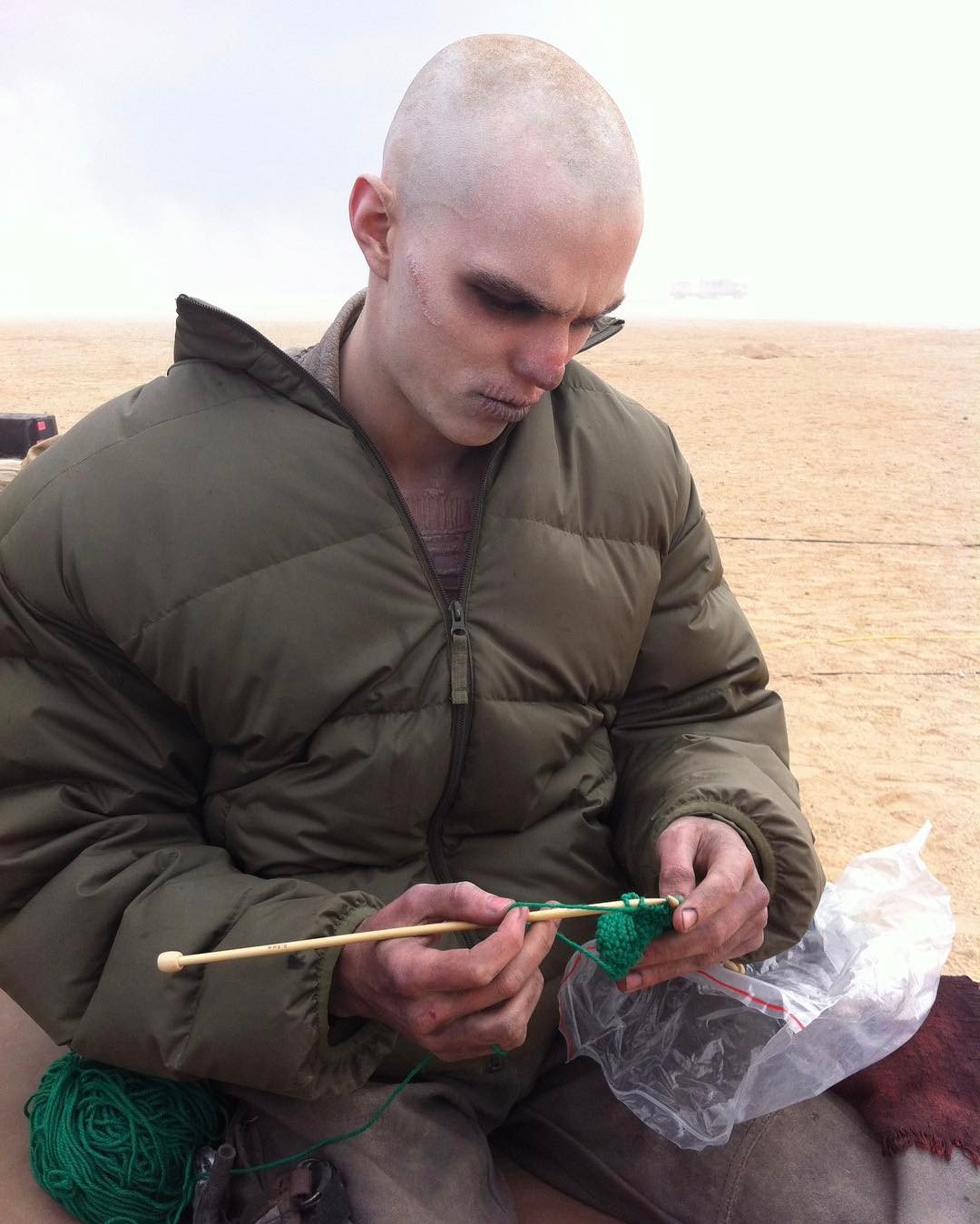 Nicholas Hoult knitting on the set of Mad Max: Fury Road.