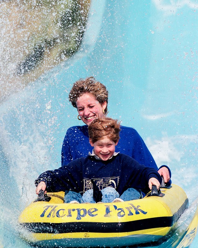 Princess Diana with her youngest son Prince Harry at an amusement park.