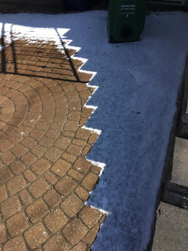 Shadow of the stairs stopping the snow from melting.