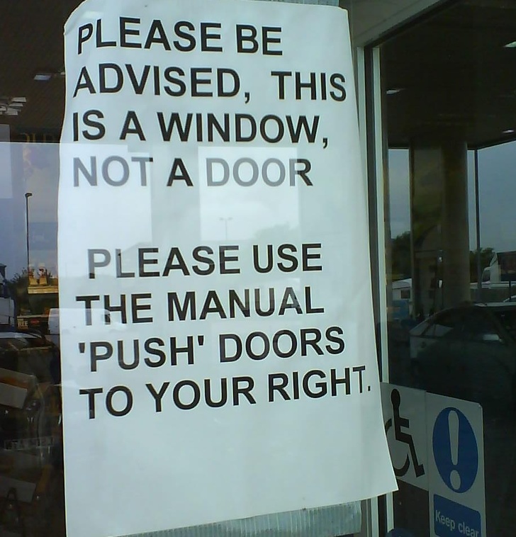 sign - Please Be Advised, This Is A Window, Not A Door Please Use The Manual 'Push' Doors To Your Right Keep clear