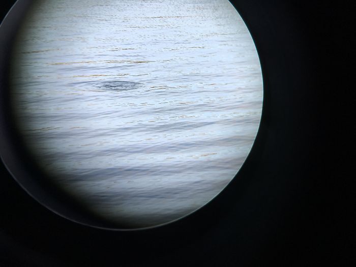 Photo taken Of A Lake Through The Lense Of Binoculars Looks Like A Planet