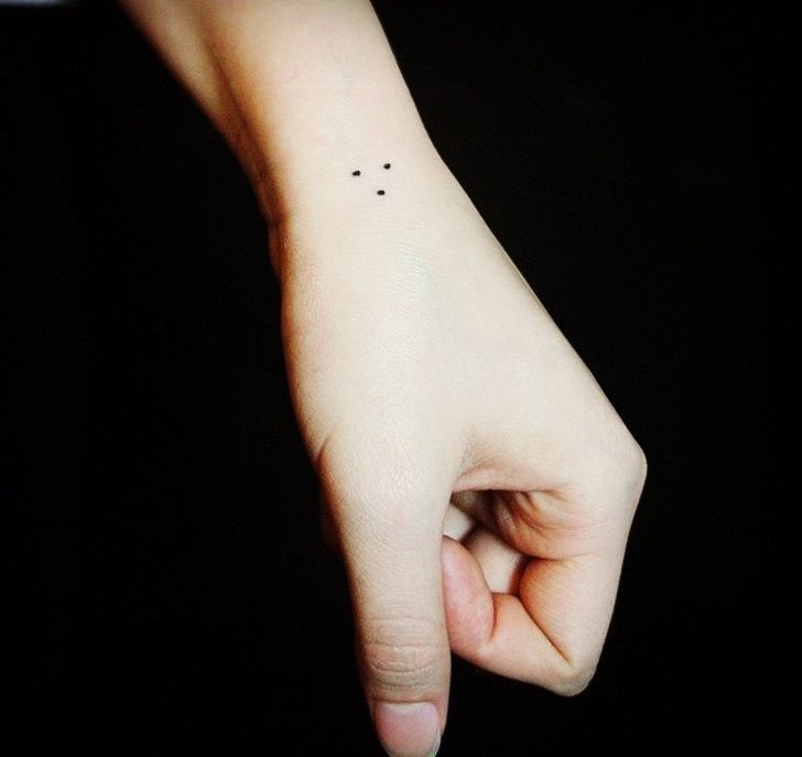 3 dots tattoo on a hand