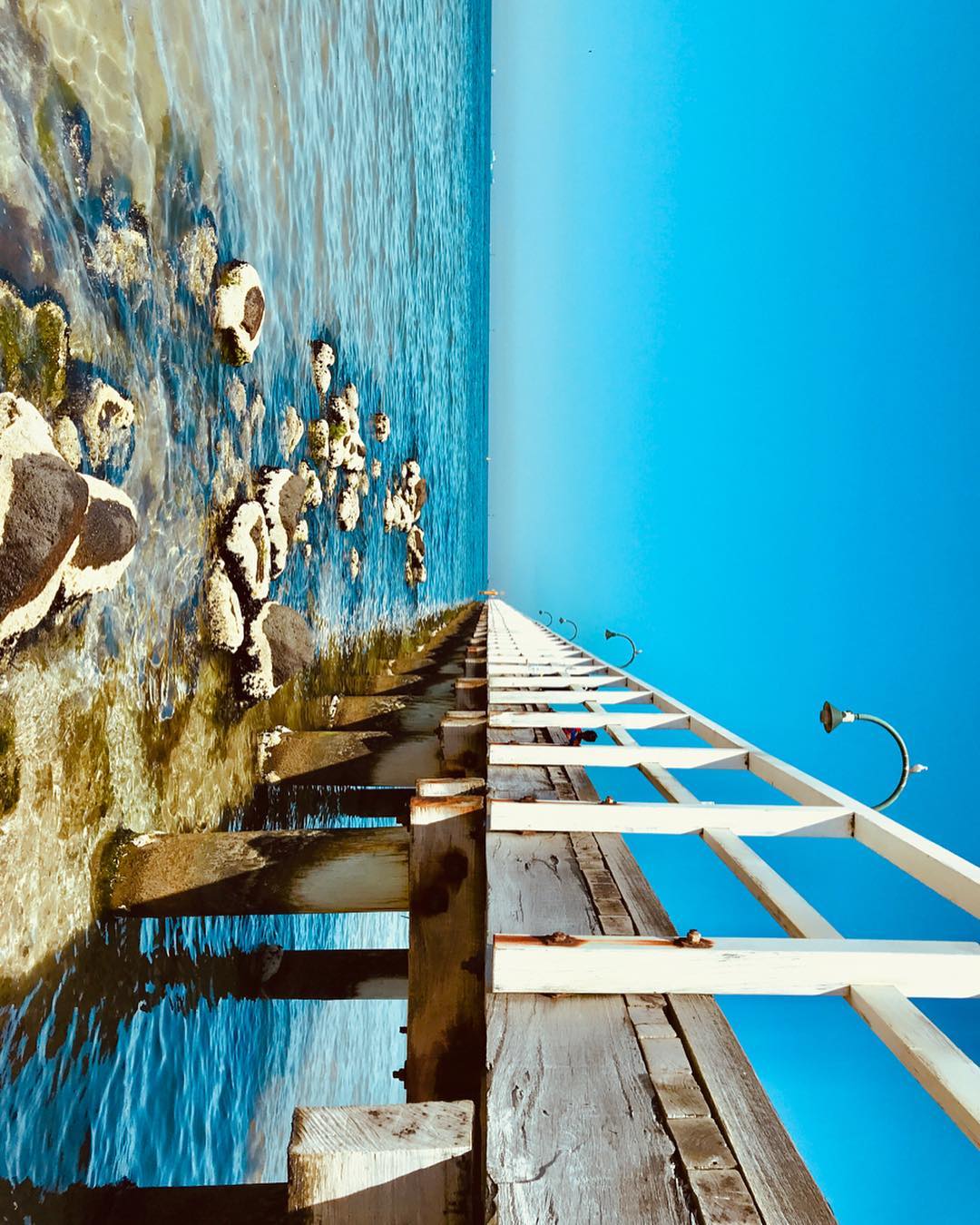 Sideways photo of a pier leading out to water
