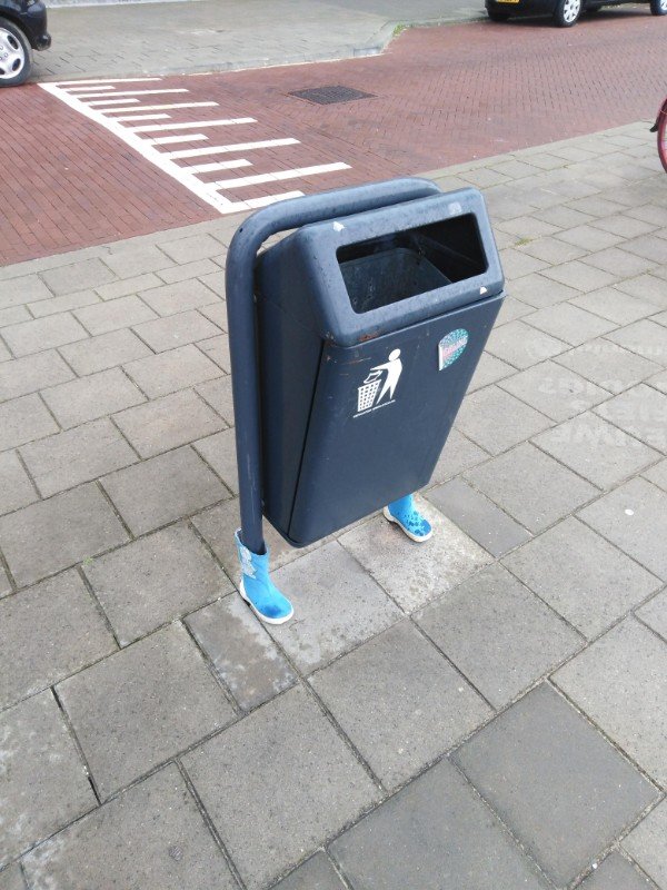 Trash can wearing boots.