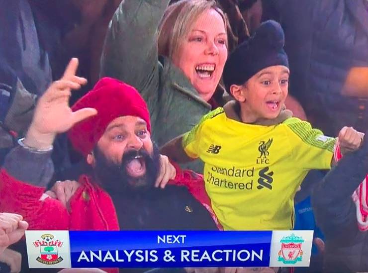 Father and son seeing their team score.