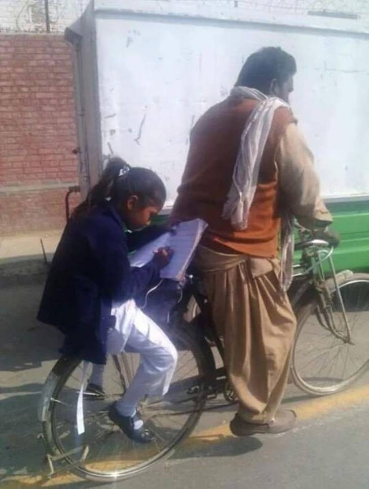 This father pedals so his daughter can do her homework.