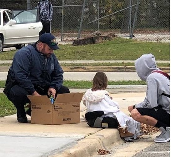 Police officer plays with a girl who was recently in an accident.