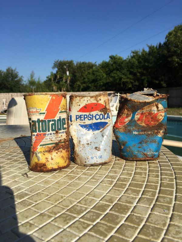 Old drink cans found buried in a backyard.