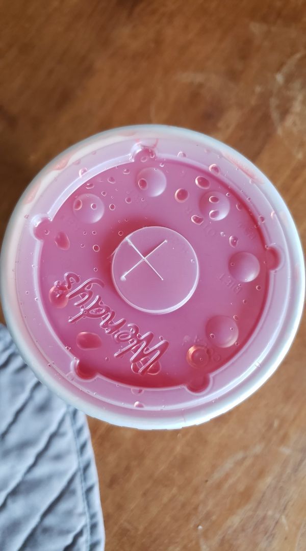 irritating images - off-center hole in a soda lid from a fast food restaurant