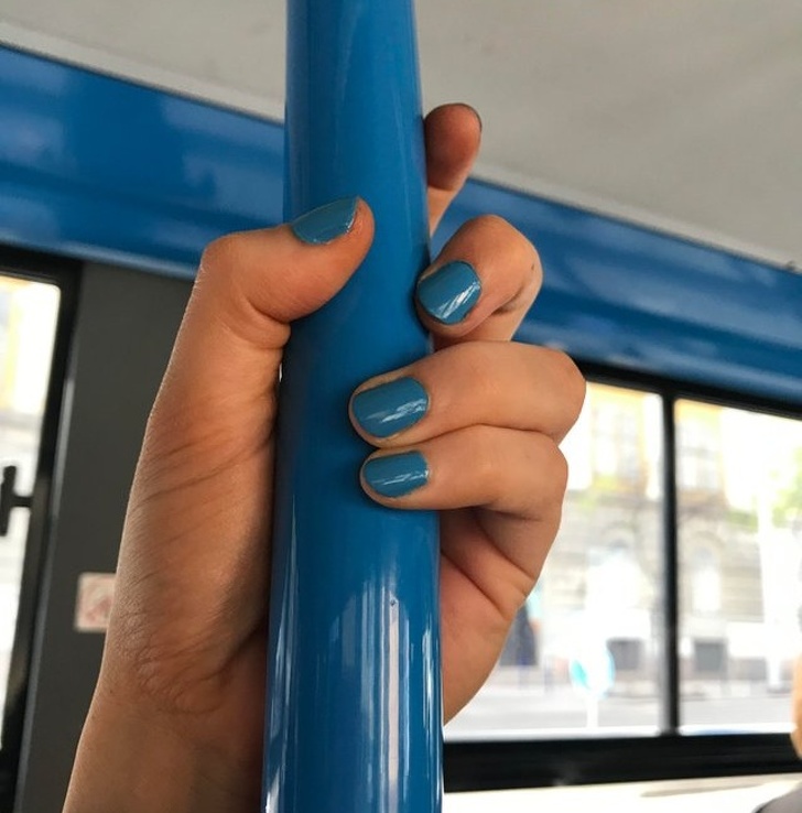 Nail polish is the same color as the bus interior.