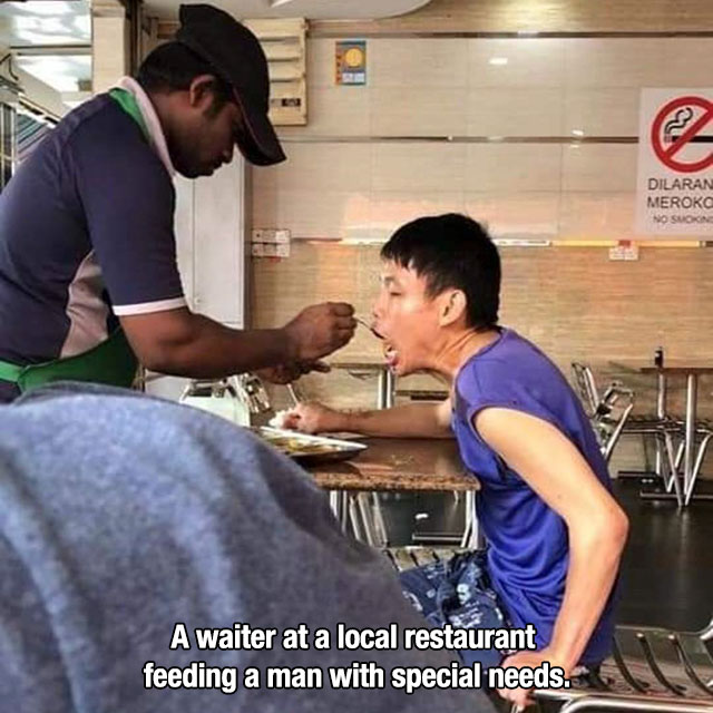 employee feeding disabled man - Dilaran Merokc No Suon A waiter at a local restaurant feeding a man with special needs.