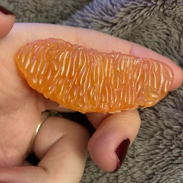 A peeled orange wedge.