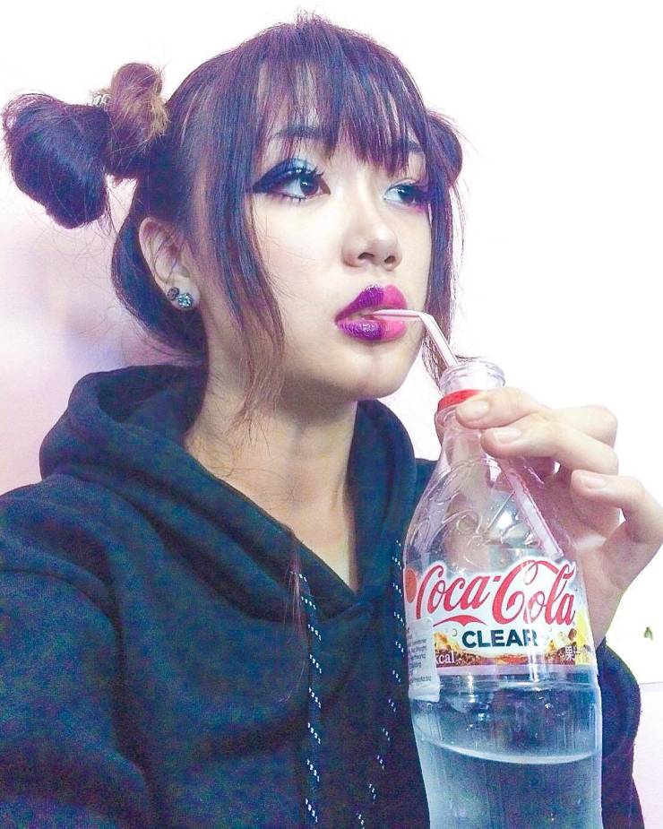 bizare things found in asia - woman drinking clear coca-cola