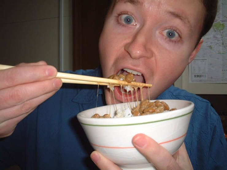 bizare things found in asia - guy eating natto, a fermented soybean