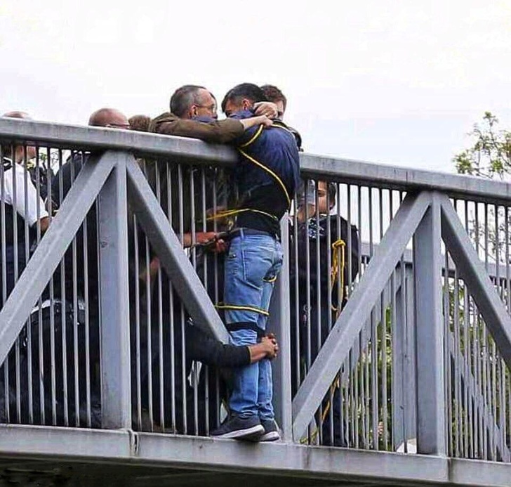 A man who tried to jump off a bridge was stopped and held by strangers.
