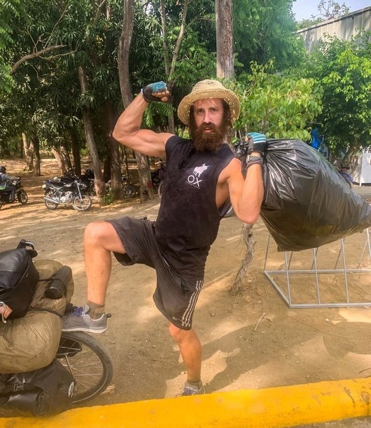 This man is picking up bags of trash on his trip through Central America.