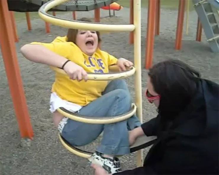 man gets stuck in kid swings