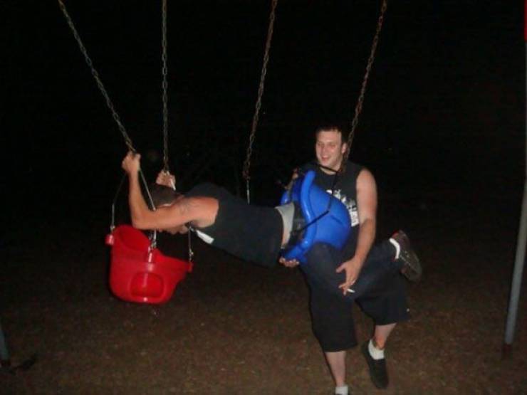 adults in a baby swing