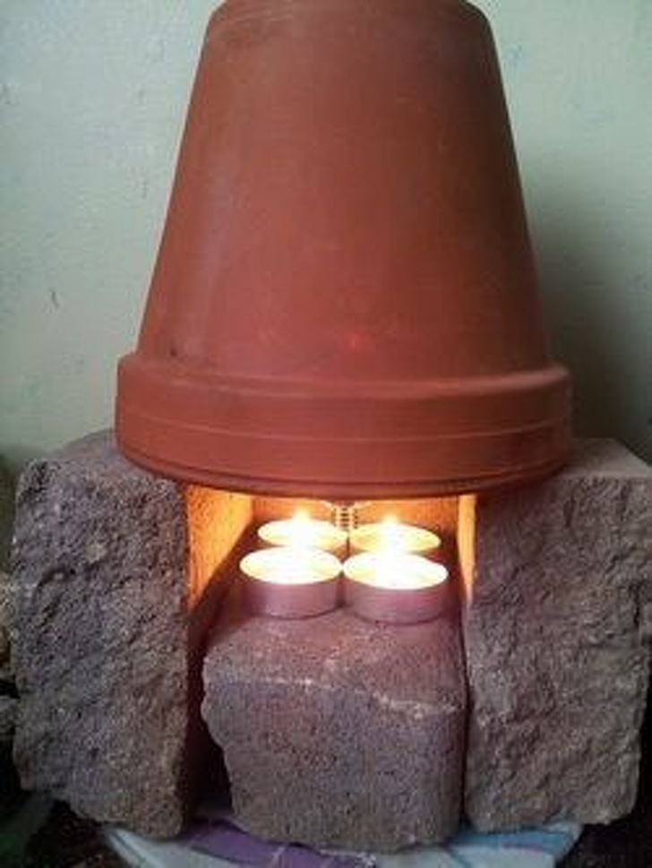 You can heat a whole room using a handmade heater. Turn a terracotta pot upside down, set it above some candles, and put some bricks around it.