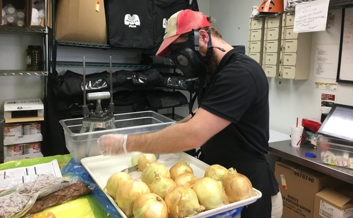 He uses a gas mask when cutting onions.