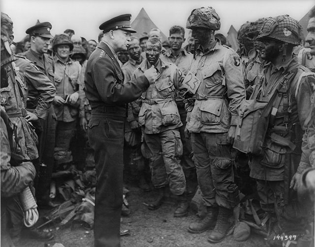 General Dwight Eisenhower speaks with US army paratroopers the day before D-Day.