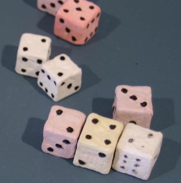 Playing dice made out of toilet paper.