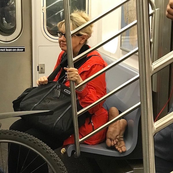 woman subway man bare feet - not lean on door