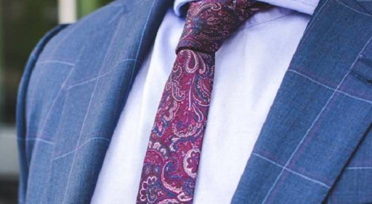 suit with red paisley tie