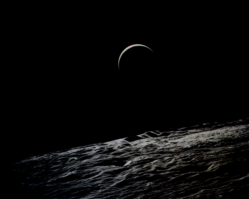 A crescent Earth seen from lunar orbit in 1971 by Apollo 15.