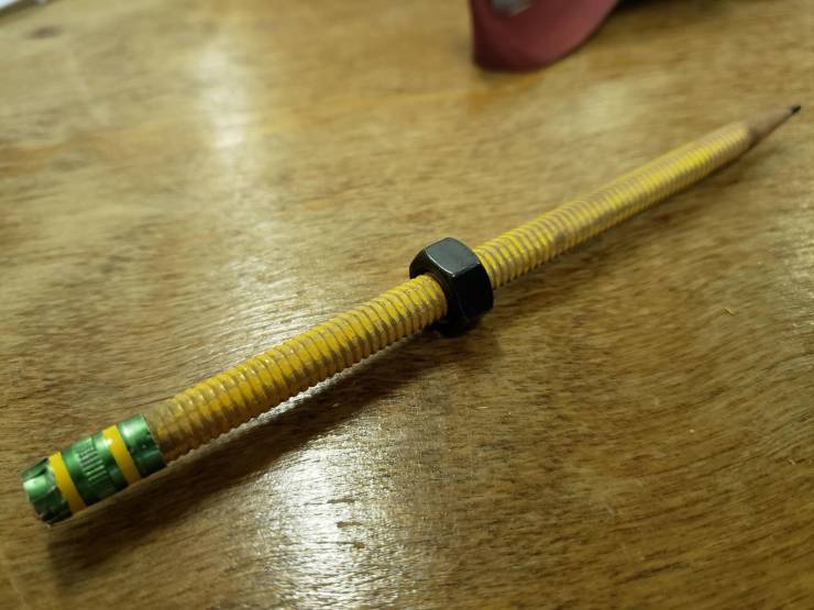 Threaded pencil with a nut.