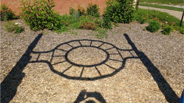 The shadow of this playground equipment looks like a TIE Fighter.