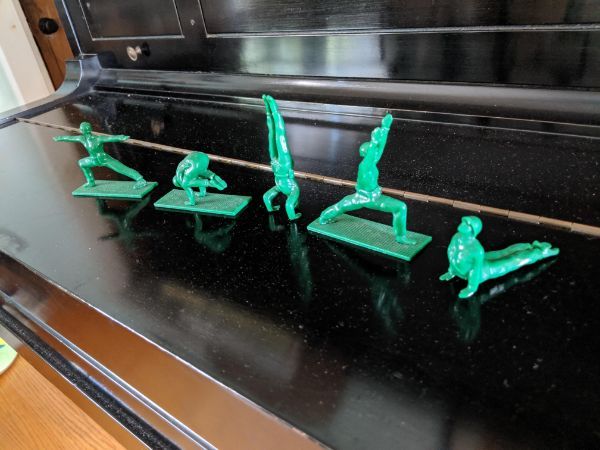 These green army men doing yoga.