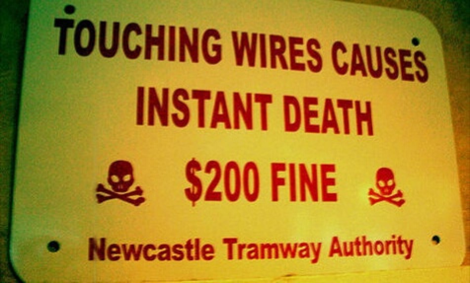 stupid road signs - Touching Wires Causes Instant Death $200 Fine Newcastle Tramway Authority