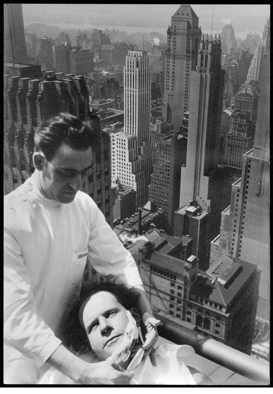 Film director Sergei Eisenstein getting a shave on top of the Chrysler building, New York City, 1930.