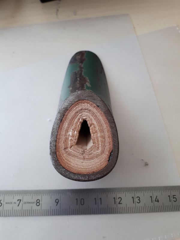 Crosscut of an old waterpipe showing the layers of limescale built up.