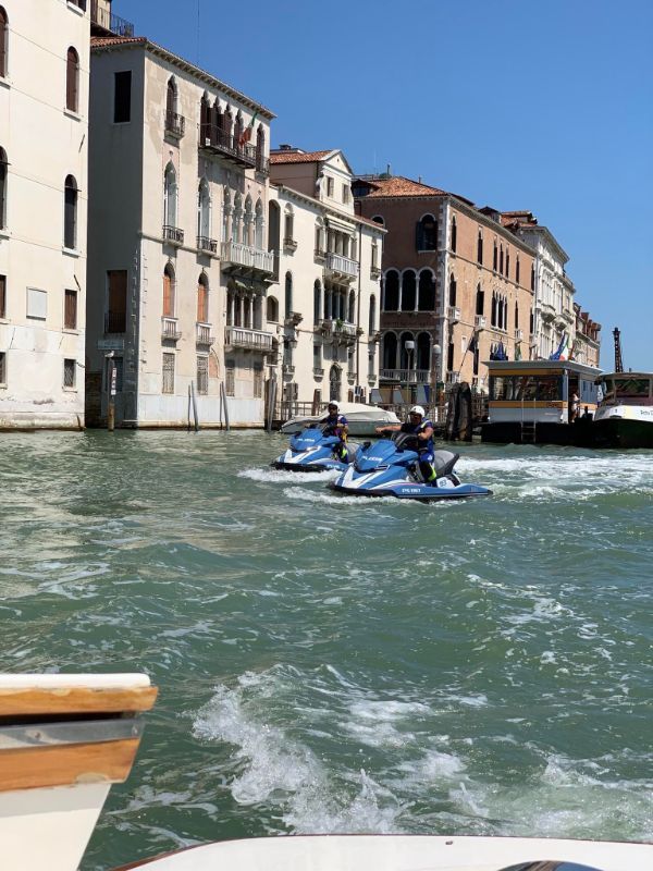 Police in Venice move around on jet skis.