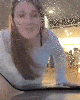 girl licks windshield