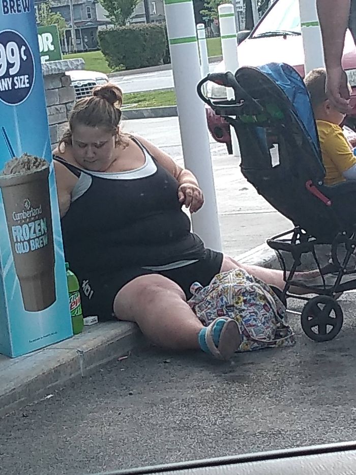 big fat woman sitting on the ground