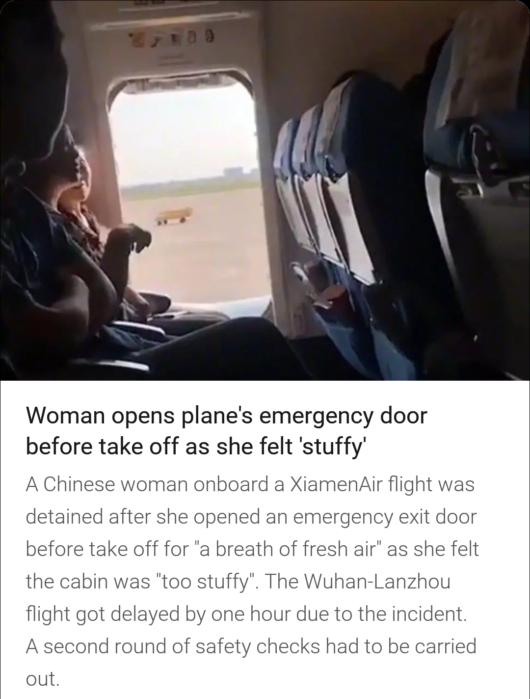 photo caption - Woman opens plane's emergency door before take off as she felt 'stuffy' A Chinese woman onboard a Xiamen Air flight was detained after she opened an emergency exit door before take off for'a breath of fresh air' as she felt the cabin was '